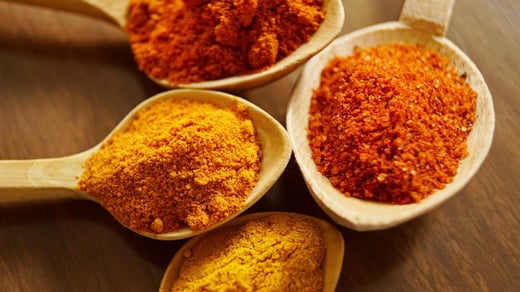 Assuaged-Powdered-Turmeric-In-Wooden-Spoons-Image
