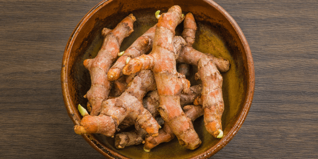 Assuaged-Whole-Turmeric-Root-in-Clay-Bowl-Image (899 x 450 px)