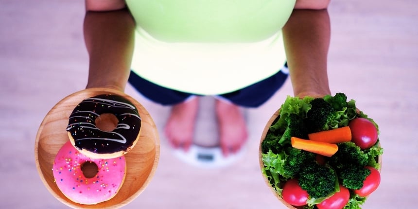 woman-holding-plate-of-doughnuts-in-right-hand-and-vegetables-in-left-hand