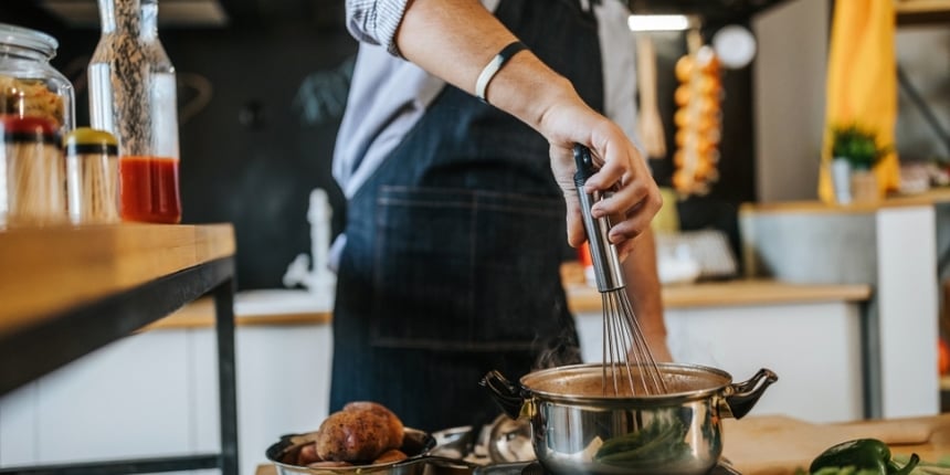 man-cooking-using-a-whisk