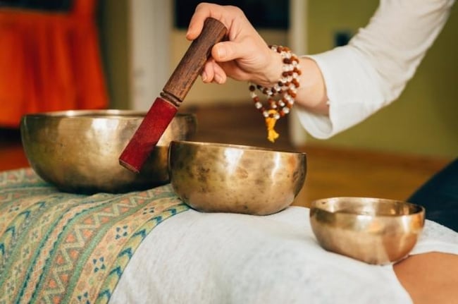 woman-playing-Tibetan-bowl-mediation-music 