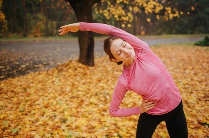 woman-stretching-and-exercising-in-park