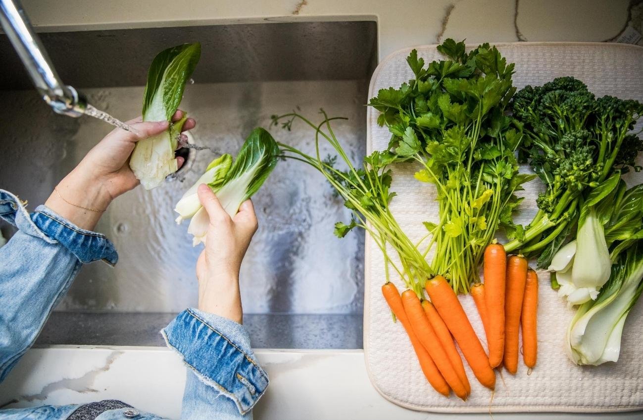 woman-washing-vegetables-produce-in-sink