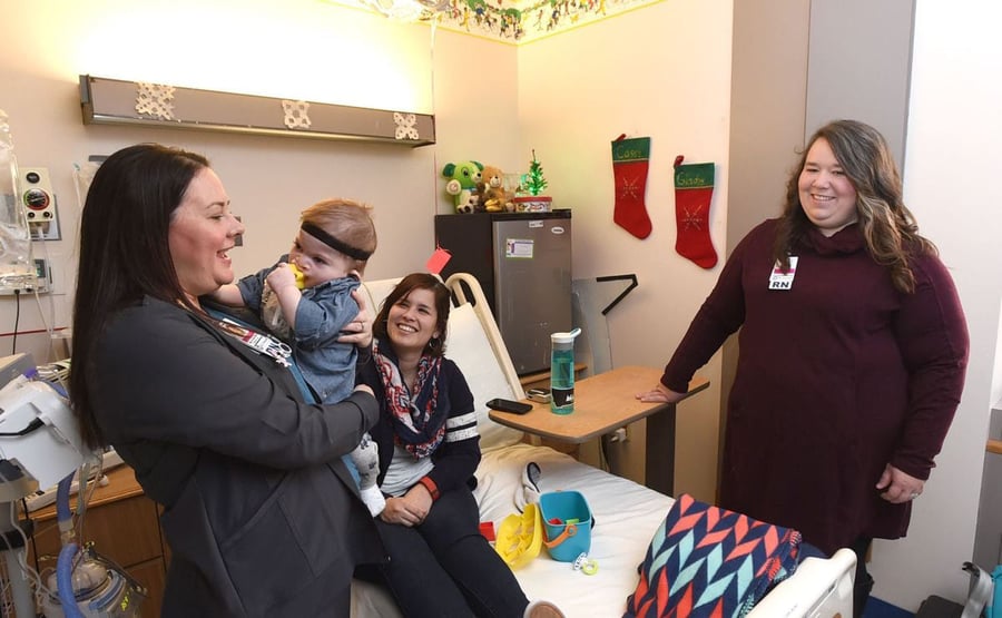 Pediatric nurse manager Amber Pisk, right, and certified pediatric nurse Bryana Reiter visit with Gladys Kanode and her baby, Forest, at St. Vincent Healthcare on Wednesday. St Vincent pediatric nurses have achieved 100 percent board certification in pediatrics. / LARRY MAYER Gazette Staff