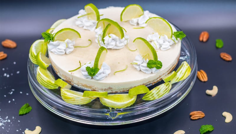 Keylime-Pie-with decorative fresh limes and vegan whipped cream dollops cashews and pecans