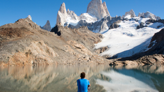 Persona sitting at lake reflecting life purpose and spiritual meaning