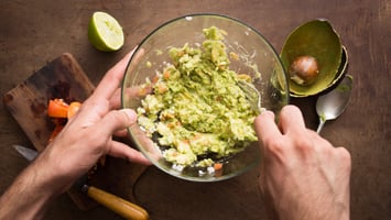 man smashing avocado mashed potatoes
