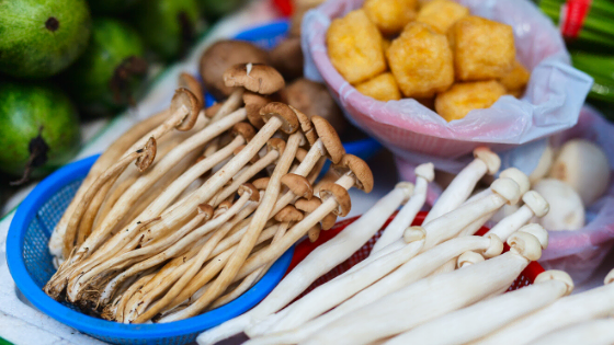 Enoki mushrooms with tofu in background