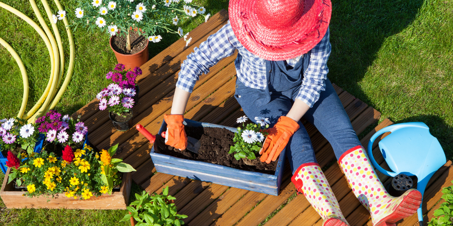 gardener-gardening-outdoors-in-hat-gardening-gloves-and-water-boots