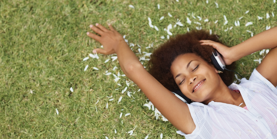 smiling-relaxed-person-touching-grass